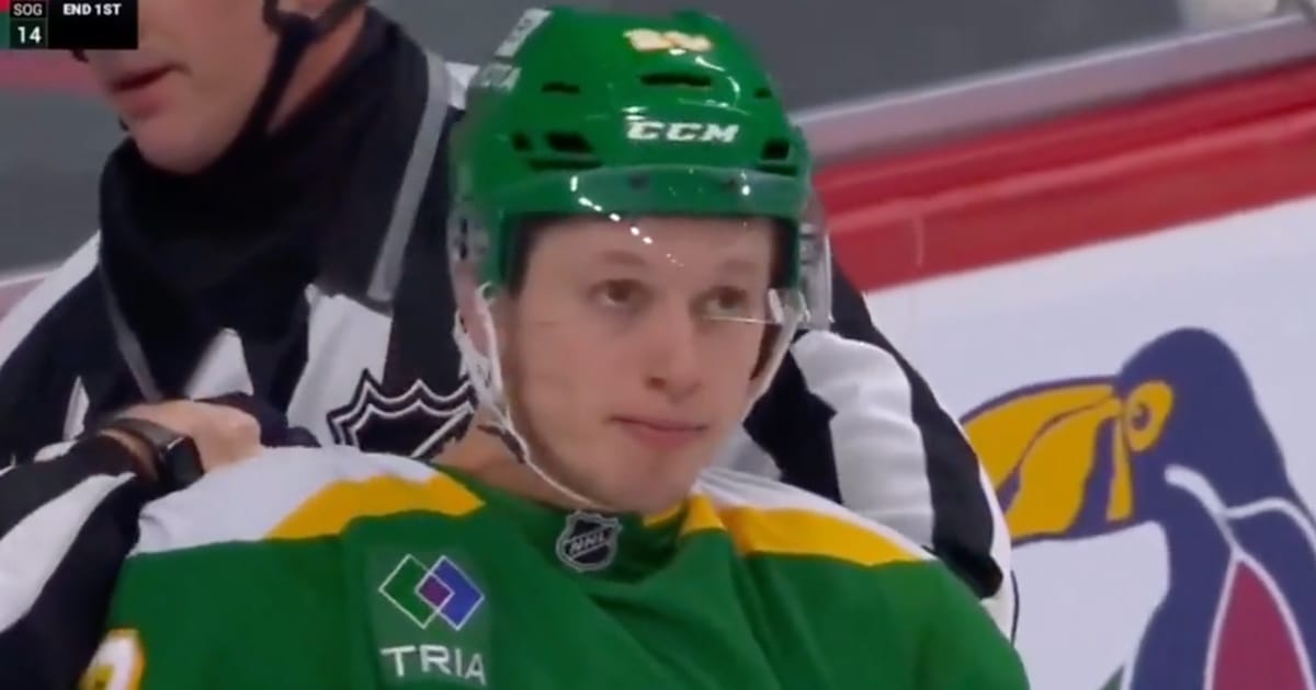 Marco Rossi in a scrum with Matthew Tkachuk