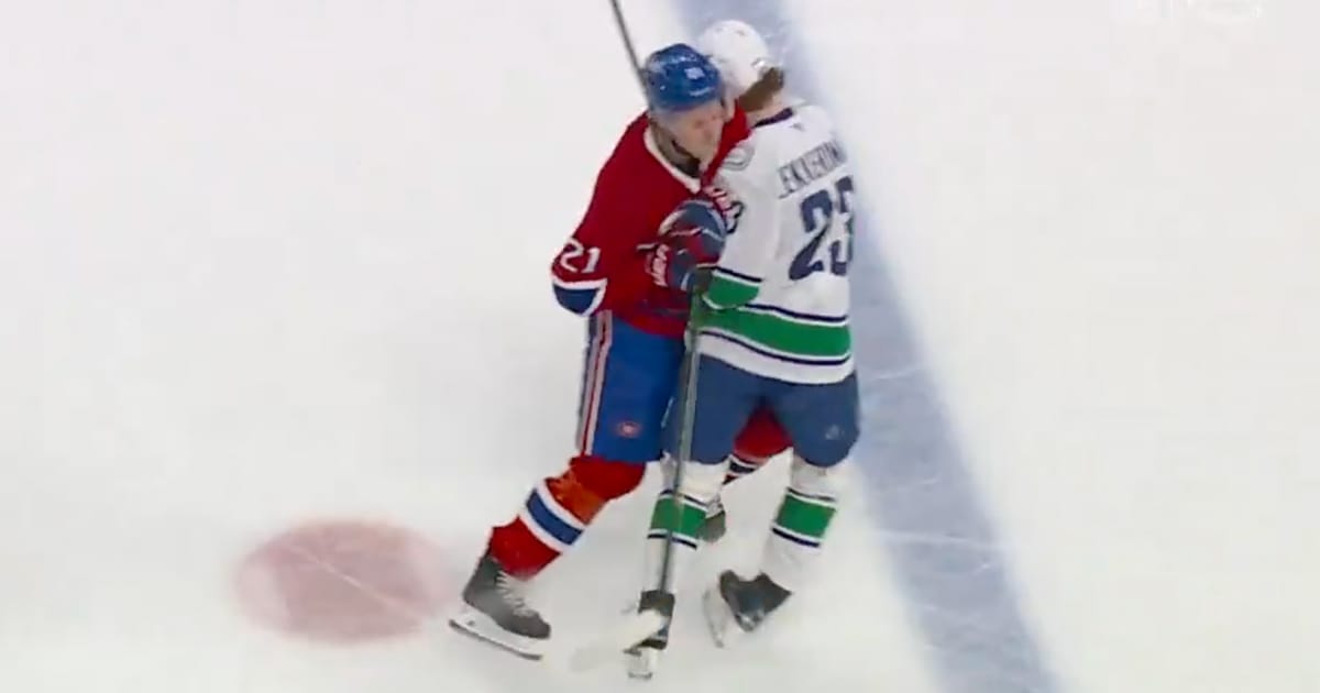 Kaiden Guhle of the Montreal Canadiens with a hit on Vancouver Canucks' Jonathan Lekkerimäki