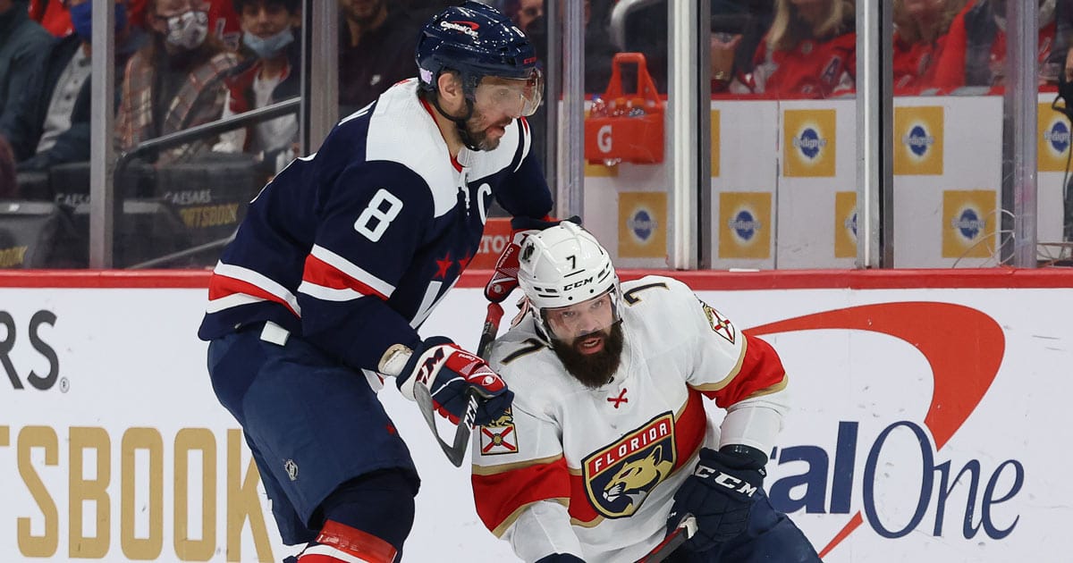 Alex Ovechkin battles with Radko Gudas